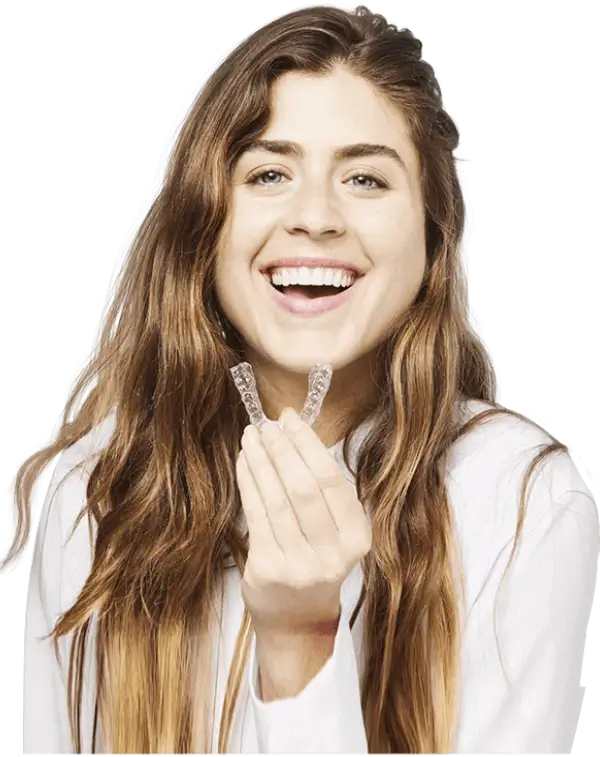 A lady holding and showcasing a clear aligner, highlighting the benefits of the best invisible aligners.